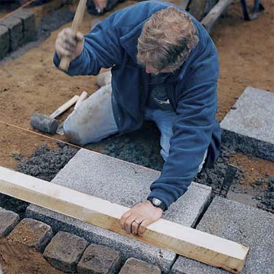 setting and leveling stones for installing the field of pavers