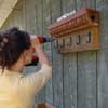 fasten cornice turned into garden tool holder to wall